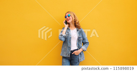 Happy cheerful young woman laughs calling on phone, girl talking on smartphone in denim clothing Happy cheerful young woman laughs calling on phone, girl talking on smartphone in denim clothing 115898019