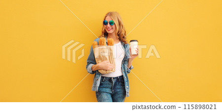 Happy bakery buyer young woman holding grocery shopping paper bag with bread baguette drinks coffee Happy bakery buyer young woman holding grocery shopping paper bag with bread baguette drinks coffee 115898021