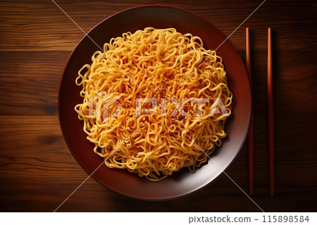 Freshly cooked delicious noodles with soun and sesame seeds in a beautiful plate on a wooden table, top view 115898584