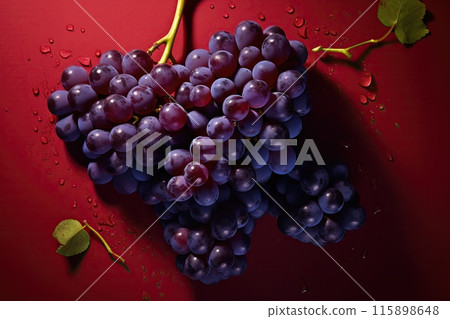 Bunches of fresh grapes in water drops on a dark background 115898648