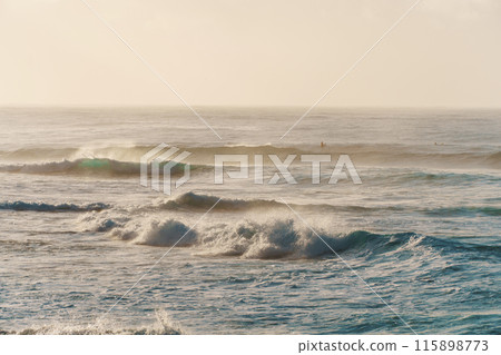 A slightly outoffocus image of waves breaking on a sandy shore A slightly outoffocus image of waves breaking on a sandy shore 115898773