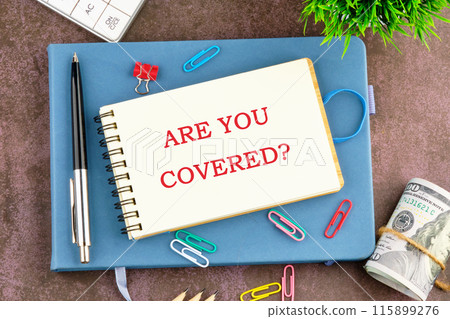 Business and Are you covered concept. Copy space. Concept word Are you covered symbol in the businessman's notebook Business and Are you covered concept. Copy space. Concept word Are you covered symbol in the businessman's notebook 115899276