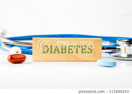 Word DIABETES on a wooden bar in front of a stethoscope next to pills, vitamins Word DIABETES on a wooden bar in front of a stethoscope next to pills, vitamins 115899293