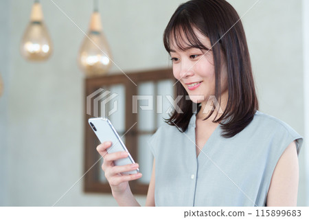 Woman using a smartphone Woman using a smartphone 115899683