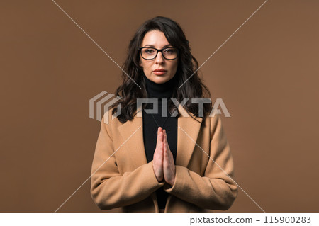 Mature Businesswoman Praying, Begs Apologize Her, She Guilty. Beige Background Mature Businesswoman Praying, Begs Apologize Her, She Guilty. Beige Background 115900283
