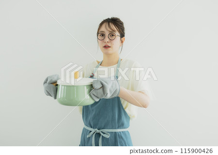 Young woman standing in the kitchen Young woman standing in the kitchen 115900426