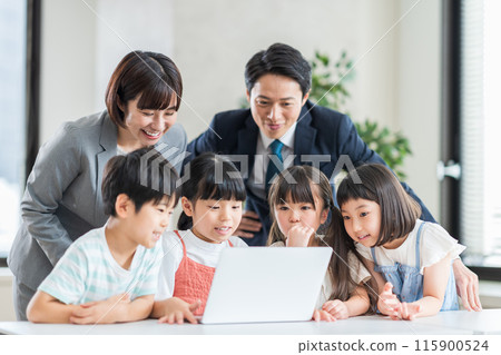 Elementary school students and a teacher taking a programming class at a cram school. 115900524