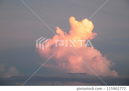 The clouds are exposed to the rays of a beautiful sunrise, Nature sky background 115902772