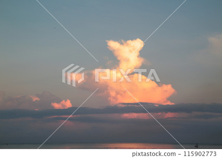 The clouds are exposed to the rays of a beautiful sunrise, Nature sky background 115902773