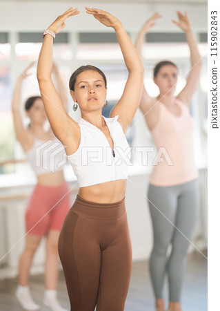 Young ballerinas rehearse ballet poses during ballet classes 115902843