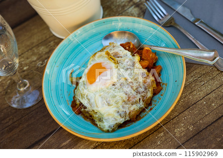 Cod fish served with eggs and garlic Cod fish served with eggs and garlic 115902969