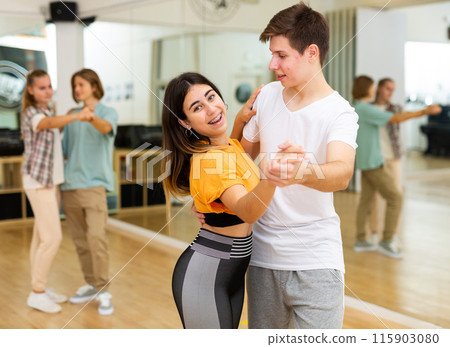 Teens dancing waltz in studio Teens dancing waltz in studio 115903080