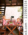 Little girl at the table offers a salad to a little boy. High quality photo 115903154