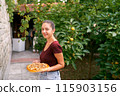 Girl in the garden with onion tarte tatin on a plate. High quality photo 115903156