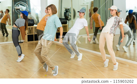 Teens performing modern dance in studio 115903202
