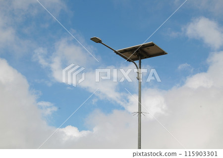 Blue Cloudy Sky and Street Lamp Minimalist Scene Blue Cloudy Sky and Street Lamp Minimalist Scene 115903301