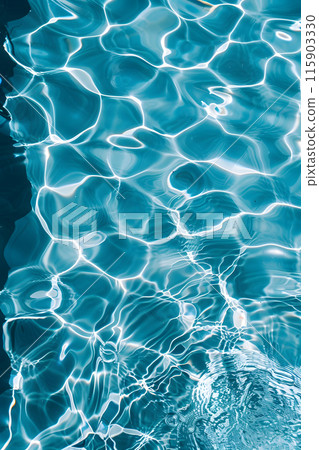 A closeup of the azure water surface in a swimming pool during daytime, showcasing the fluid nature of this body of water 115903330