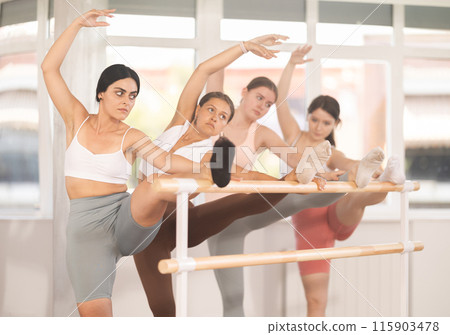 Ballet pose grand batman - young ballerinas at choreography lesson Ballet pose grand batman - young ballerinas at choreography lesson 115903478