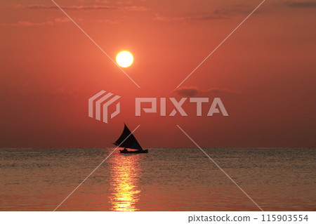 Beautiful sunrise on the sea and silhouette of a fishing boat Beautiful sunrise on the sea and silhouette of a fishing boat 115903554