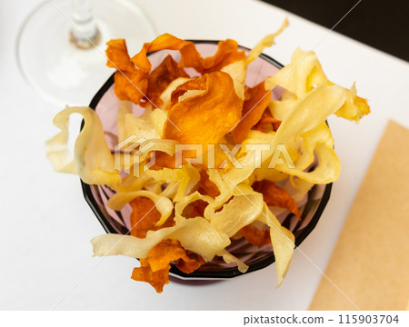 Bowl of crispy manioc and sweet potato chips Bowl of crispy manioc and sweet potato chips 115903704