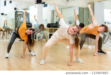 Teens performing modern dance in studio Teens performing modern dance in studio 115903807