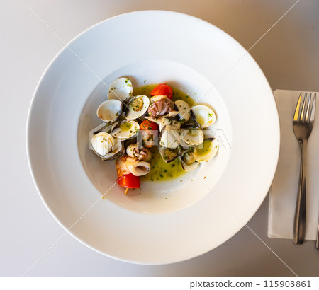 Squid skewer with garlic and clams Squid skewer with garlic and clams 115903861