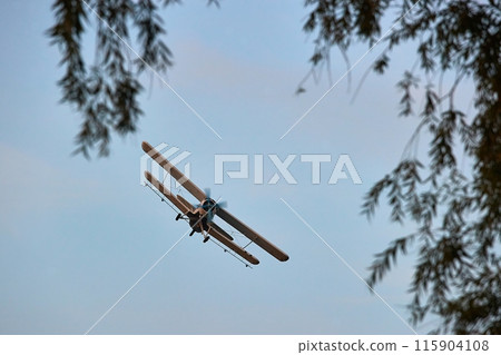Old propeller plane in the sky 115904108