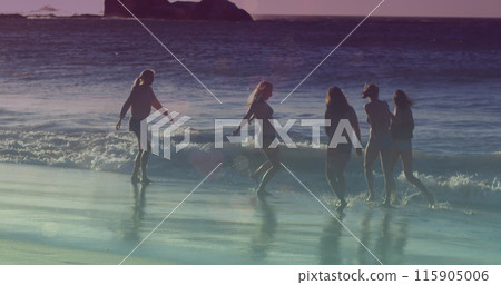 Image of glowing lights over group of female friends by the sea 115905006