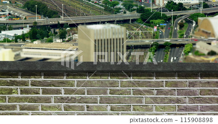 Image of brick wall over busy city 115908898