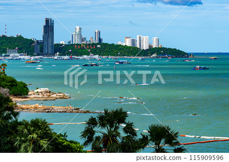 View of Pattaya Bay in the morning with parasailing and other many sport activities. View of Pattaya Bay in the morning with parasailing and other many sport activities. 115909596