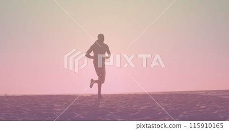 Image of over african american man running at beach 115910165