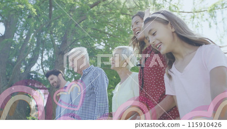 Image of failing hearts shapes over caucasian family outside Image of failing hearts shapes over caucasian family outside 115910426