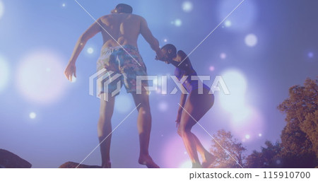 Image of glowing spots over diverse couple holding hands Image of glowing spots over diverse couple holding hands 115910700