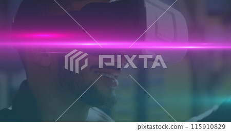 Image of blue and pink light trails moving over biracial man wearing vr headset Image of blue and pink light trails moving over biracial man wearing vr headset 115910829