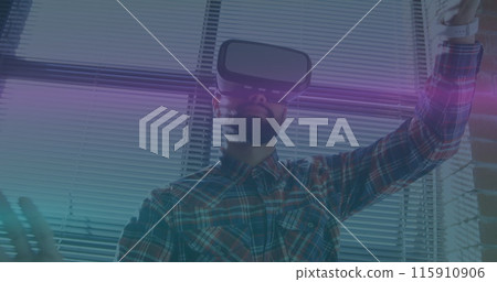 Image of blue and pink light trails moving over biracial man wearing vr headset at office Image of blue and pink light trails moving over biracial man wearing vr headset at office 115910906