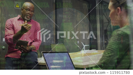 Image of diverse coworkers discussing plans on laptop against globe, graphs and trading board 115911780