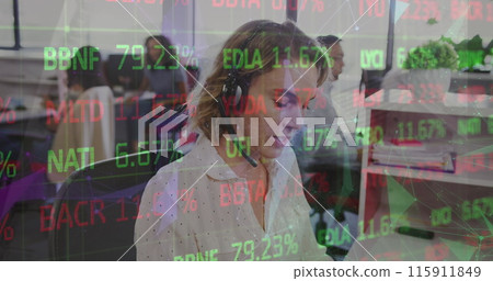 A businesswoman is talking on the phone in a busy office 115911849