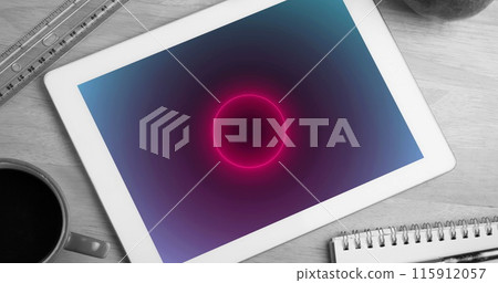 Image of tablet with neon circles moving on screen on desk Image of tablet with neon circles moving on screen on desk 115912057