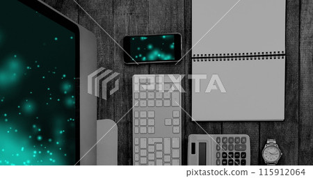 Image of technological devices with light spots on screen on desk 115912064