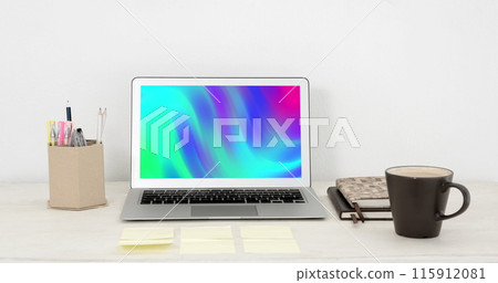 Image of laptop with colorful moving shapes on screen on desk 115912081