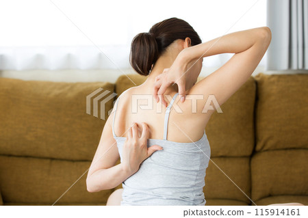 Young woman scratching her back. Young woman scratching her back. 115914161