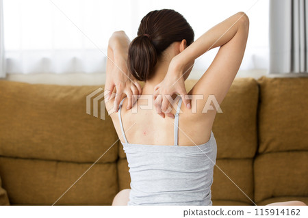 Young woman scratching her back. Young woman scratching her back. 115914162