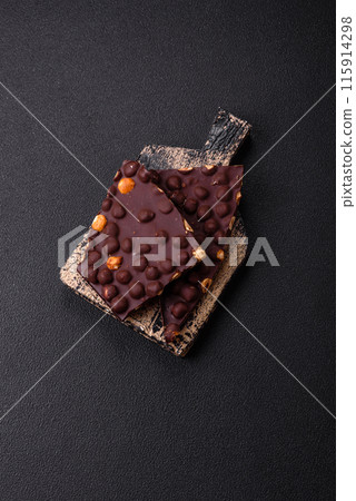 Black bitter chocolate with whole hazelnuts, candied fruits and mint Black bitter chocolate with whole hazelnuts, candied fruits and mint 115914298