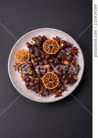 Black bitter chocolate with whole hazelnuts, candied fruits and mint Black bitter chocolate with whole hazelnuts, candied fruits and mint 115914389