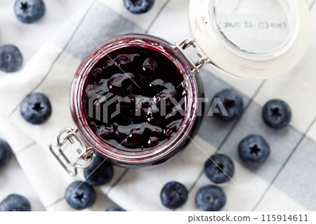 Blueberry jam with fresh berries on white marble table background. Selective focus. 115914611