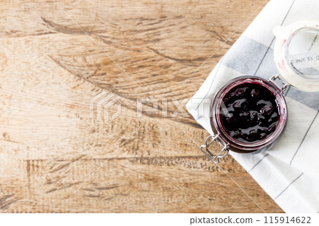 Blueberry jam with fresh berries on rustic wooden table background. Selective focus. 115914622