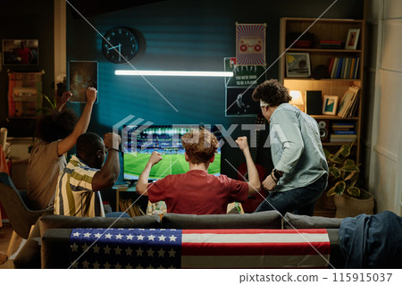 Rear view of ethnically diverse male friends spending evening in living room watching soccer match on TV, copy space Rear view of ethnically diverse male friends spending evening in living room watching soccer match on TV, copy space 115915037