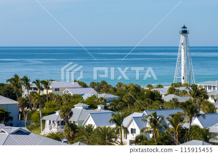 Large residential homes and tall lighthouse in island small town Boca Grande on Gasparilla Island in southwest Florida. American waterfront houses in rural US suburbs Large residential homes and tall lighthouse in island small town Boca Grande on Gasparilla Island in southwest Florida. American waterfront houses in rural US suburbs 115915455