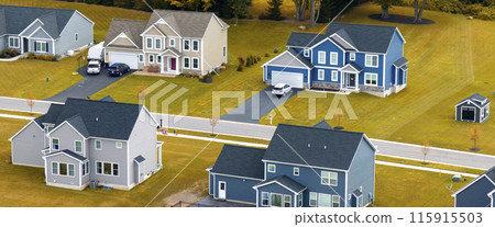 Low-density two story private homes with large lot size and green grassy lawns in summer season. Rural residential suburbs with upscale suburban houses outside of Rochester, New York Low-density two story private homes with large lot size and green grassy lawns in summer season. Rural residential suburbs with upscale suburban houses outside of Rochester, New York 115915503