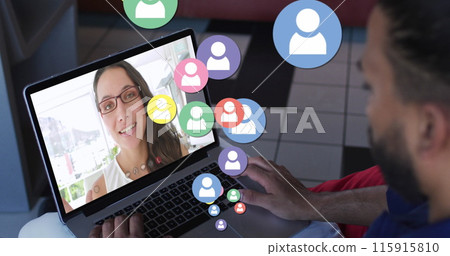 Image of profile icons floating against rear view of biracial man having a image call on laptop 115915810
